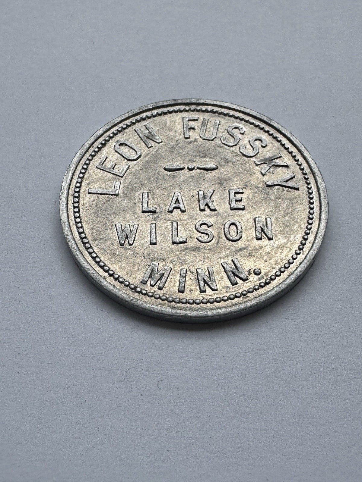 Leon Fussky Lake Wilson MN $1 Aluminum Trade Token – Rare Vintage Store Token