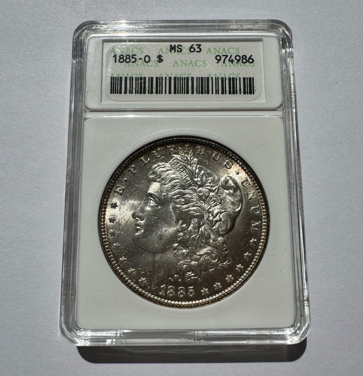 1885-O Morgan Silver Dollar – ANACS MS63 – Old Soapbox Holder, Scarce “O”