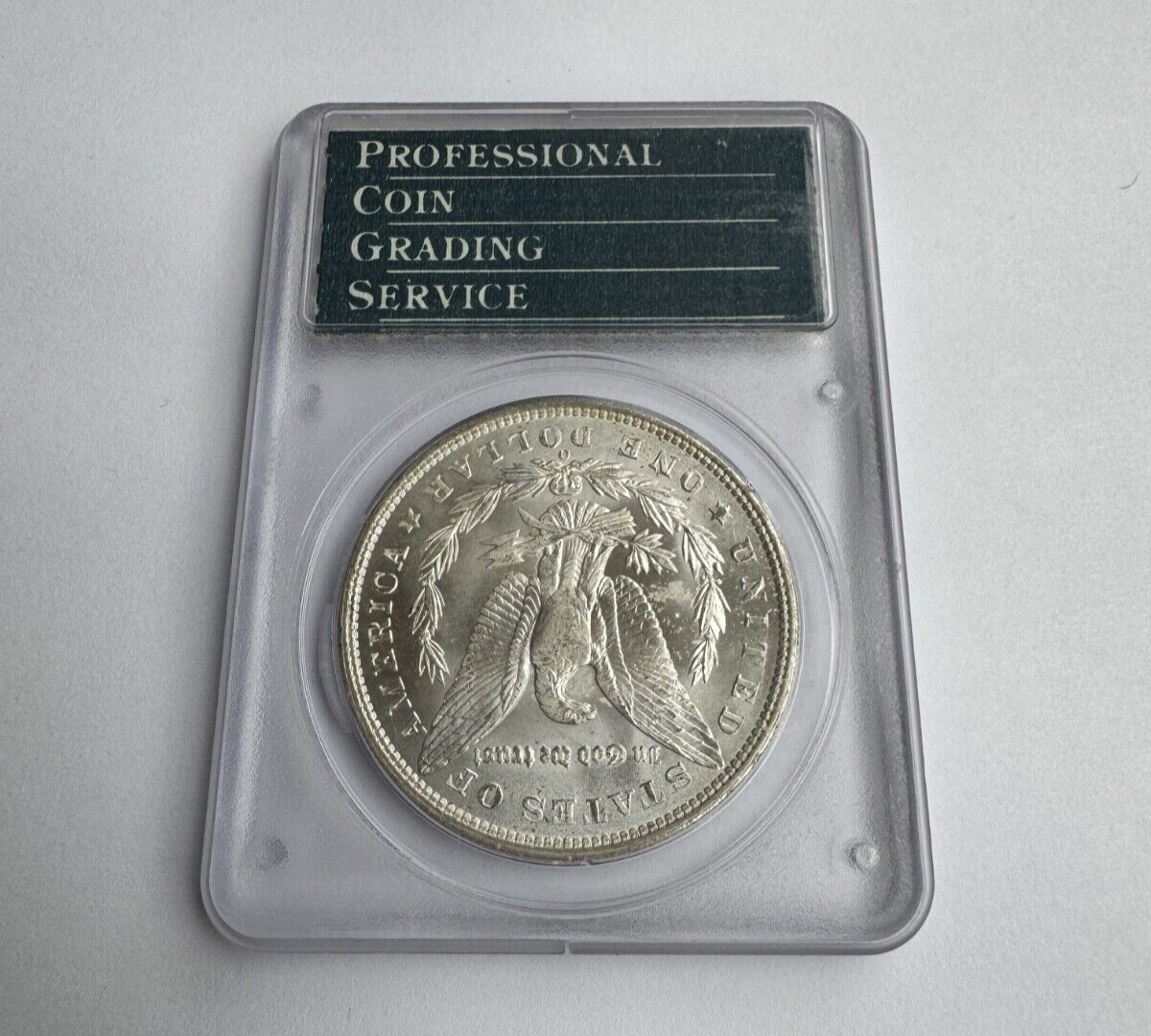 1904-O Morgan Silver Dollar – PCGS Certified MS62 – *Vintage Rattler Holder*
