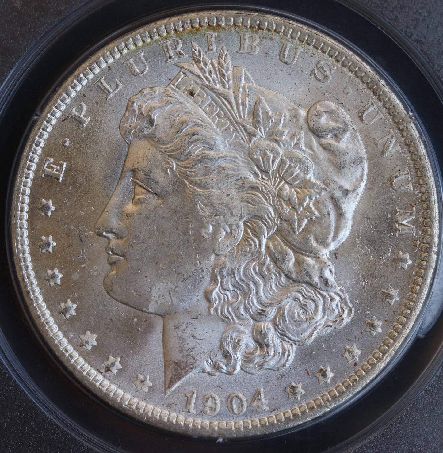 1904-O Morgan Silver Dollar – PCGS Certified MS62 – *Vintage Rattler Holder*